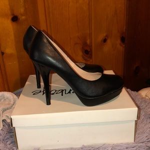 Black platform pumps